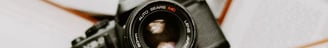 black nikon dslr camera on white printer paper