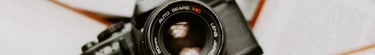 black nikon dslr camera on white printer paper