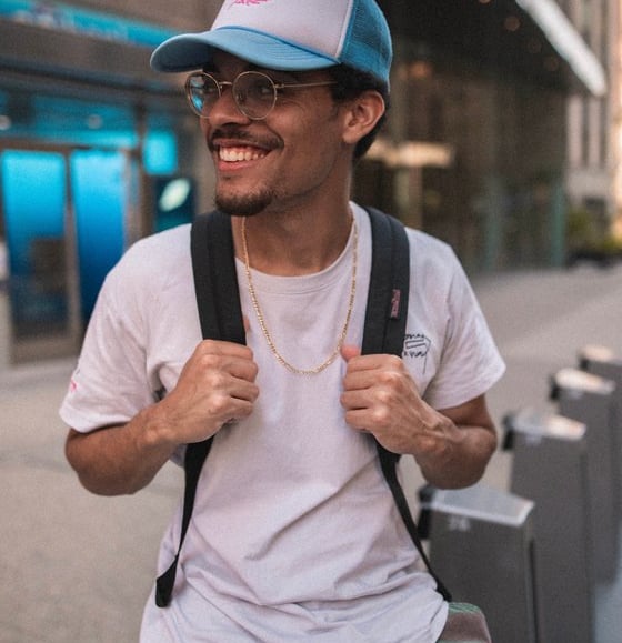 man in white crew neck t-shirt wearing blue cap and black sunglasses